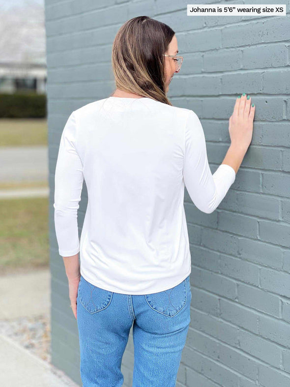Woman standing with her back towards the camera showing the back of Miik's Wesley cropped cardigan