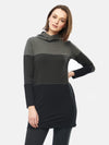 Woman standing in front of a wall wearing Miik's Hasha colourblock twisted cowl tunic in grey stripe and leggings.