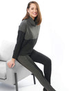 Woman sitting on a chair wearing Miik's Oaklynn colour block cowl top in grey with matching leggings.
